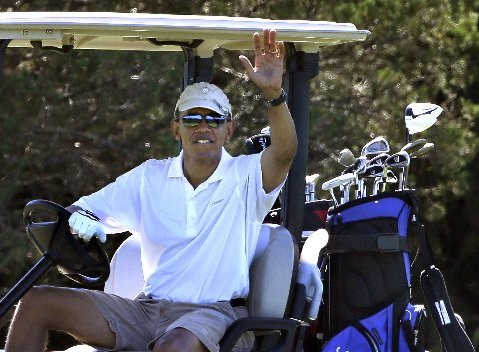 President Barack Obama waves to a group of on-lookers while golfing at Farm Neck Golf Club in Oak Bluffs, Mass., on the island of Martha's Vineyard, Sunday, Aug. 11, 2013. (AP Photo/Steven Senne)