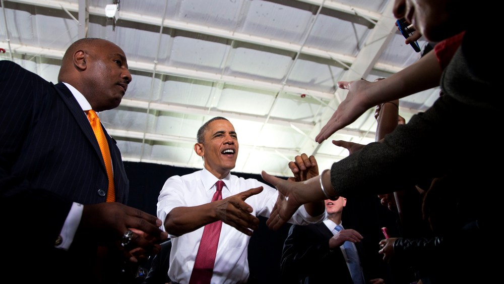 President Barack Obama shakes hands with audience members as he arrives at North Carolina State University to speak about the economy, jobs and manufacturing, Jan. 15, 2014.