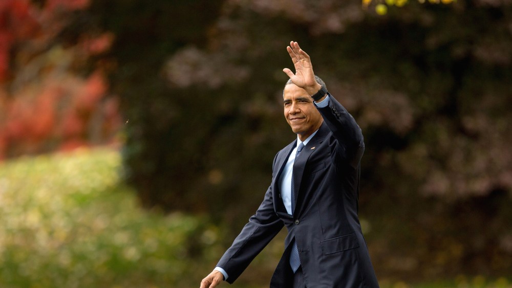 President Barack Obama waves to visitors as he walks towards Marine One on the South Lawn of the White House in Washington, D.C., Nov. 2, 2015. (Photo by Andrew Harnik/AP)