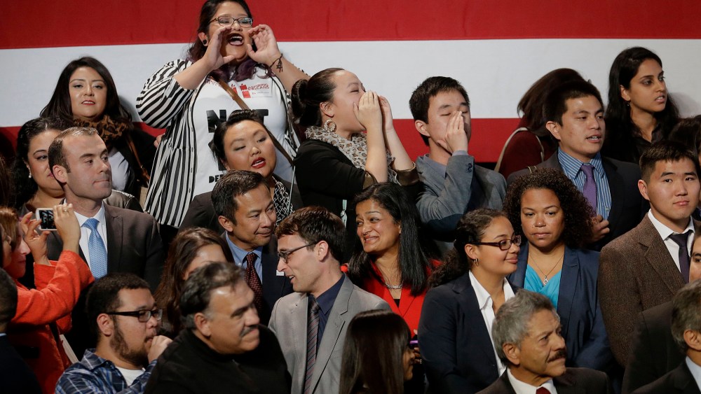 A group yells immigration reform chants at President Barack Obama as he leaves after speaking about immigration reform, Monday, Nov 25, 2103, at the Betty Ann Ong Chinese Recreation Center in San Francisco.