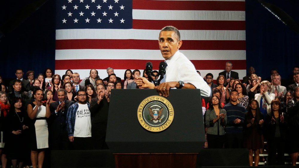 President Barack Obama turns around to respond to hecklers interrupting his speech about immigration reform, Nov. 25, 2013.