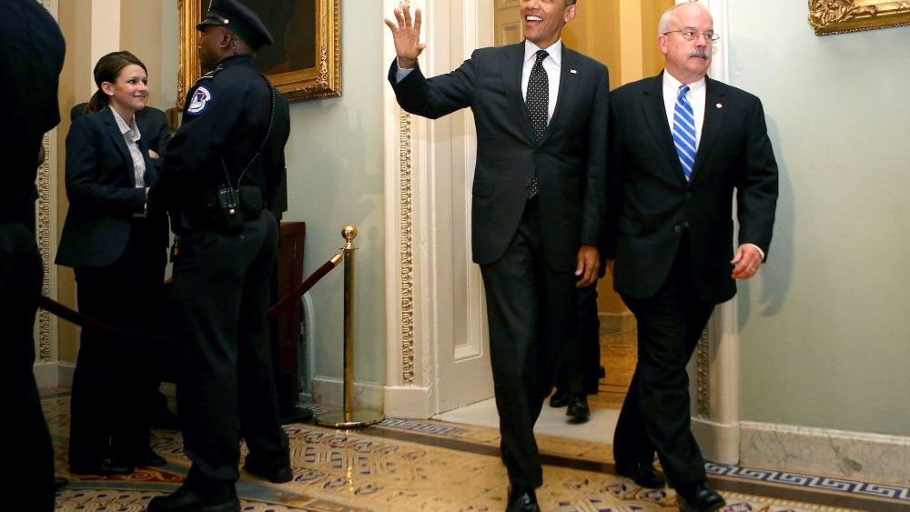 United States President Barack Obama is accompanied by Sergeant at Arms of the U.S. Senate Terrance Gainer...