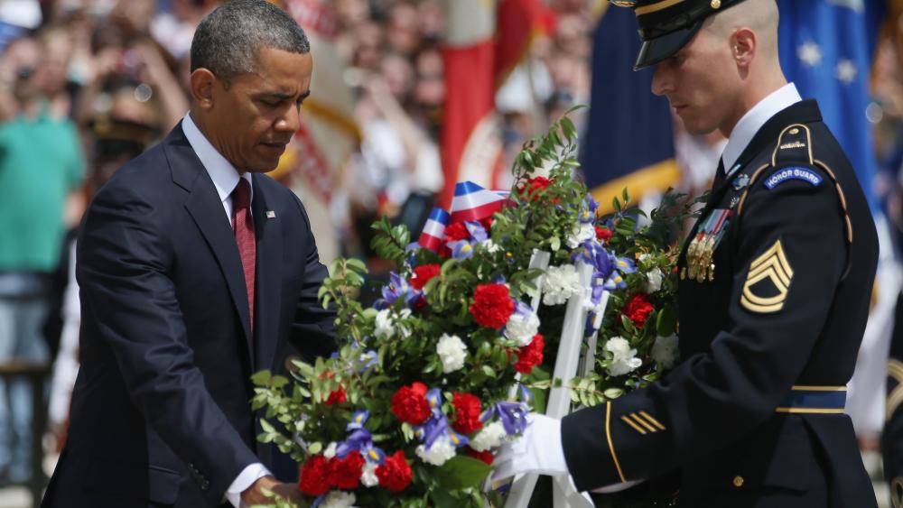 President Barack Obama positions a commemorative wreath during a ceremony on Memorial Day at the Tomb of the Unknowns at Arlington National Cemetery on May 27, 2013 in Arlington, Va. (Photo by Mark Wilson/Getty Images)