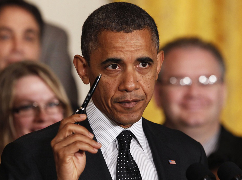 President Barack Obama holds up a pen as he delivers a statement on the "fiscal cliff" in the East Room of the White House in Washington, November 9. The president he was ready to sign a bill "right away" to extend the Bush tax cuts for the bottom 98%...