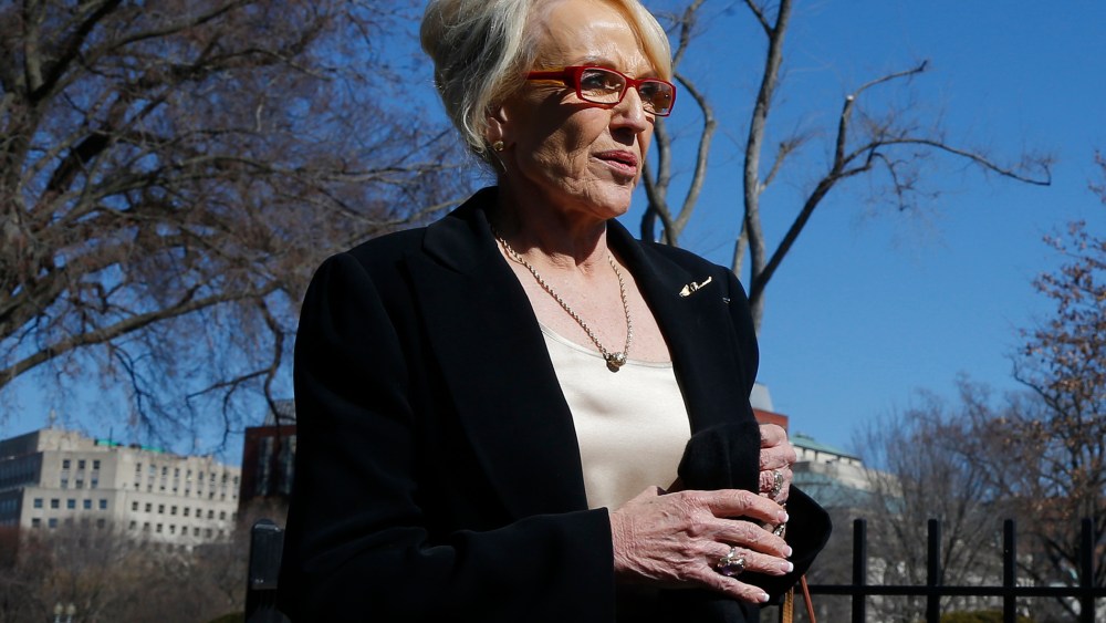 Arizona Gov. Jan Brewer walks towards the West Wing of the White House in Washington, Monday, Feb. 24, 2014.