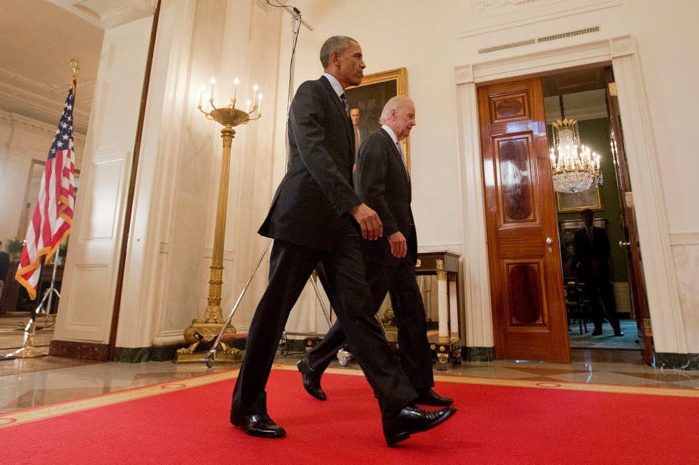 President Barack Obama walks with Vice President Joe Biden, after delivering remarks in the East Room of the White House in Washington, D.C., July 14, 2015, after an Iran nuclear deal is reached. (Photo by Pablo Martinez Monsivais/AP)