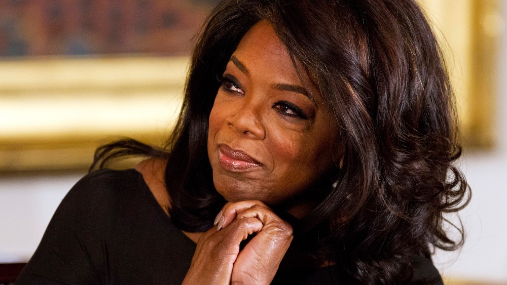 Winfrey listens in the East Room of the White House in Washington, Nov. 20, 2013.