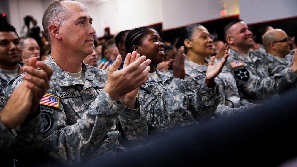 Members of the military applaud as President Barack Obama speaks about the Veteransâ Access to Care through Choice, Accountability, and Transparency Act, Aug. 7, 2014.