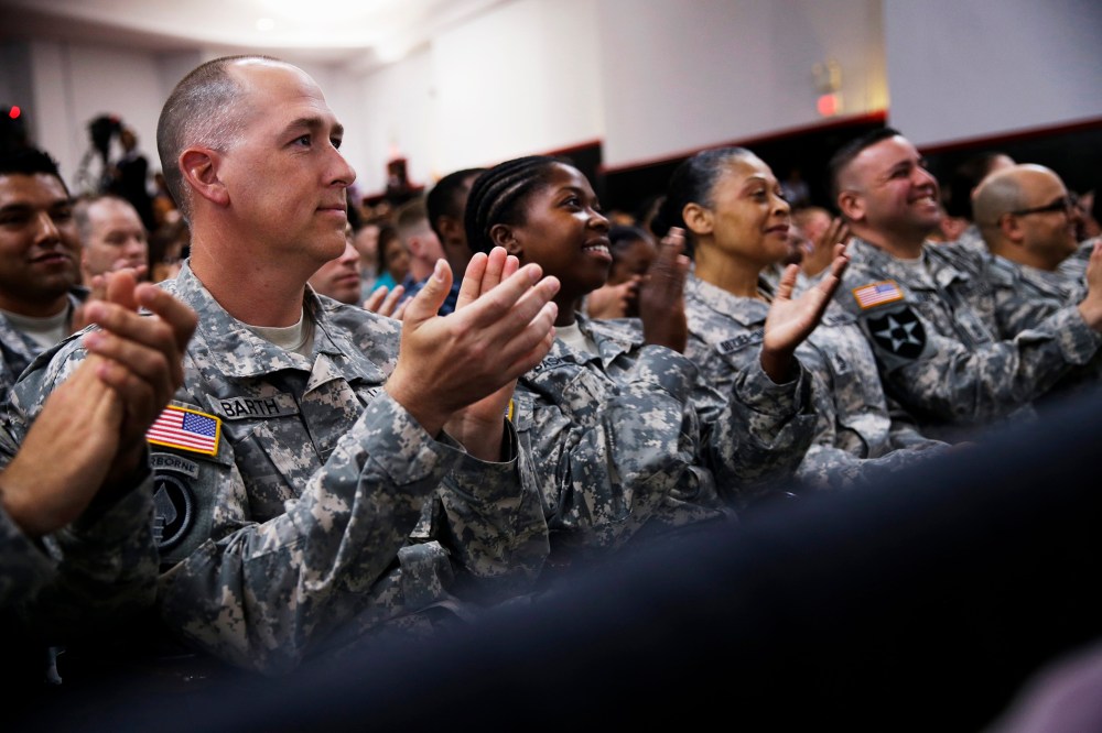 Members of the military applaud as President Barack Obama speaks about the Veteransâ Access to Care through Choice, Accountability, and Transparency Act, Aug. 7, 2014.