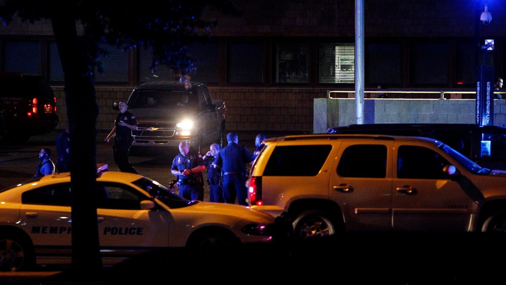 In this Saturday, Aug. 1, 2015, photo, Memphis police officers gather at Regional Medical Center in Memphis, Tenn., after officer Sean Bolton was fatally shot during a traffic stop in Memphis. (Mark Weber/The Commercial Appeal/AP)