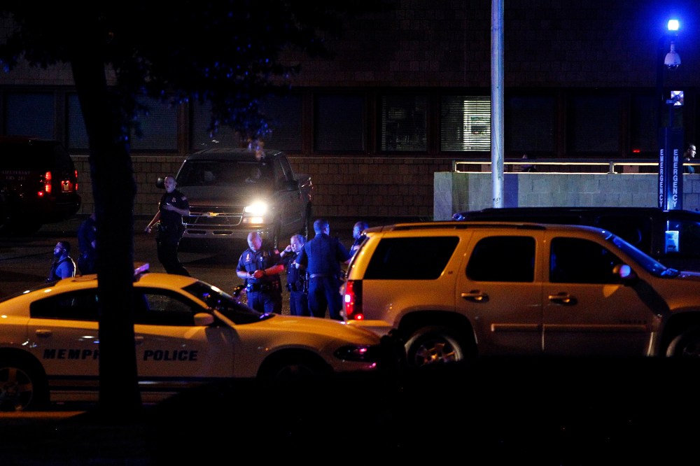 In this Saturday, Aug. 1, 2015, photo, Memphis police officers gather at Regional Medical Center in Memphis, Tenn., after officer Sean Bolton was fatally shot during a traffic stop in Memphis. (Mark Weber/The Commercial Appeal/AP)