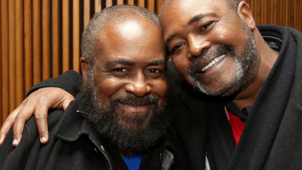 Ronnie Bridgeman, right, now known as Kwame Ajamu, hugs his brother, Wylie Bridgeman, after charges were dismissed on Dec. 9, 2014, in Cleveland, Ohio. (Tony Dejak/AP)