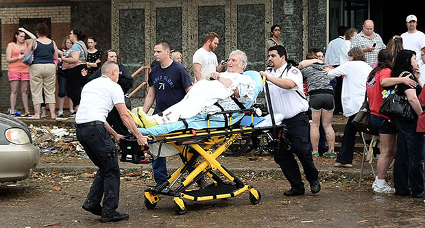 A man is taken away from the IMAX theater that was used as a triage area after a tornado that destroyed buildings and overturned cars struck Moore, Oklahoma, May 20, 2013.  A huge tornado with winds of up to 200 miles per hour (320 kph) devastated the...