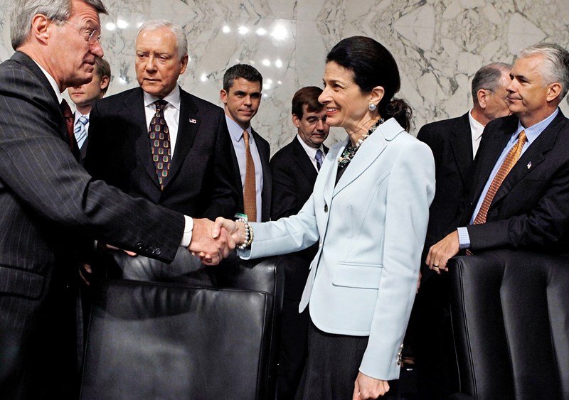 Senate Finance Committee Chairman Max Baucus (D-MT) (L) thanks  Sen. Olympia Snowe (R-ME) for voting in favor of health care reform legislation as committee Republicans Sen. Orrin Hatch (R-UT) and Sen. John Ensign (R-NV) watch, on Capitol Hill October...