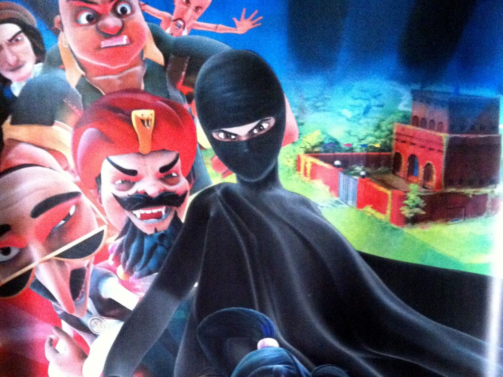This Thursday, July 11, 2013 photo shows a poster for the "Burka Avenger" cartoon series, which is scheduled to start running on Geo TV in early August. (AP Photo/Sebastian Abbot)