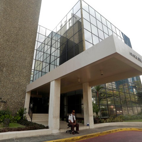 A security guard sit outside the the Mossack Fonseca law firm in Panama City, Sunday, April 3, 2016. (Photo by Arnulfo Franco/AP)