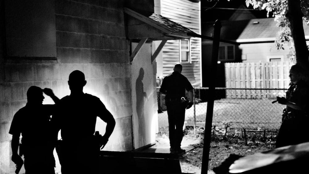 Police officers search for a suspect in Rochester, NY, 2012.