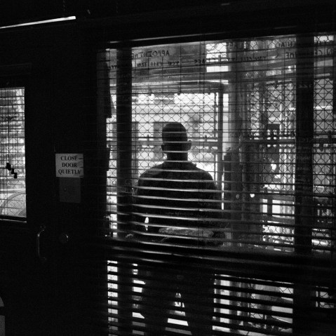Views through the fenced-in guard post into the common area of a cell block in Camp 6 of Guantanamo Bay in 2012. (Photo by Paolo Pellegrin/Magnum Photos)