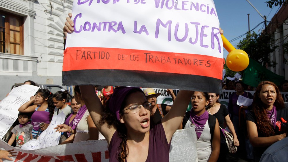 International Women's Day in Asuncion, Paraguay, Friday, March 8, 2013. The poster reads in Spanish "Enough violence against women." (Photo by Jorge Saenz/AP Photo)