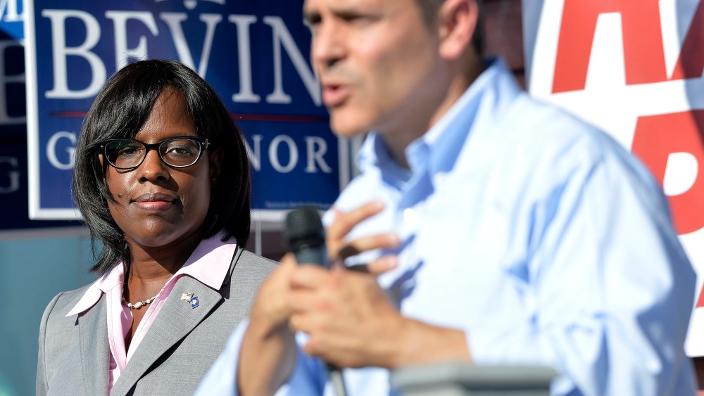 Kentucky Republican Lt. Gubernatorial candidate Jenean Hampton, left, looks on as her running mate, Gubernatorial candidate Matt Bevin, addresses their supporters from the steps of the Bevin campaign headquarters in Somerset Ky., Aug. 21, 2015.