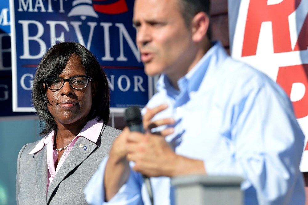 Kentucky Republican Lt. Gubernatorial candidate Jenean Hampton, left, looks on as her running mate, Gubernatorial candidate Matt Bevin, addresses their supporters from the steps of the Bevin campaign headquarters in Somerset Ky., Aug. 21, 2015.