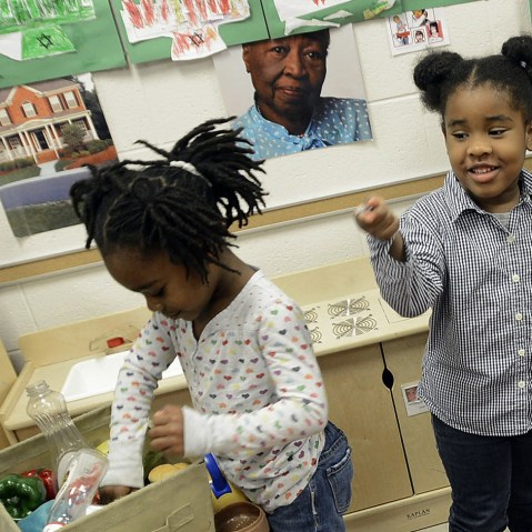 Gov. Bev Perdue, right, listens to Amaya Bryant and Jalynn Brandon, left,  Monday, Dec. 10, 2012, at Primary Colors Early Learning Center in Durham, N.C. Perdue visited the Pre-K classes to highlight the importance of preschool. (AP Photo/The Herald...