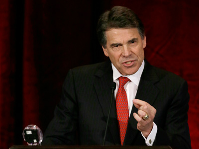 Governor Rick Perry addresses a large audience in attendance at the National Right To Life Convention on June 27, 2013, in Grapevine, Texas. (Photo by Tony Gutierrez/AP)