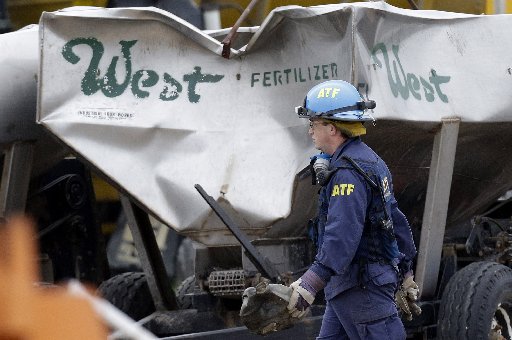 An investigators carries a piece of debris amid the destroyed fertilizer plant in West, Texas, Thursday, May 2, 2013. (AP Photo/Pool/ LM Otero)