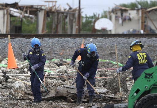 Investigators use hard rakes to sift through the debris of the destroyed fertilizer plant in West, Texas, Thursday, May 2, 2013. (AP Photo/Pool/ LM Otero, Pool)