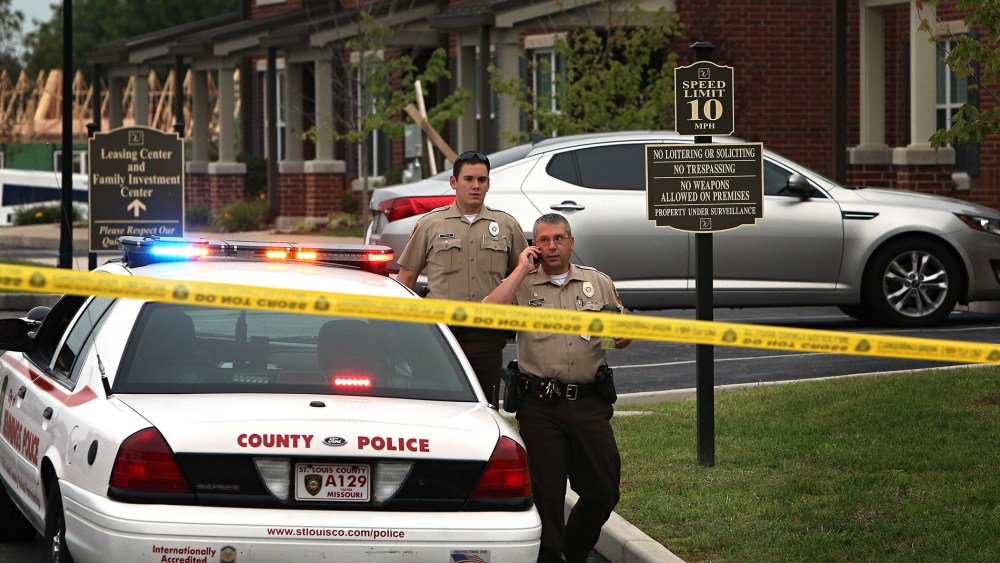 St. Louis County police officers investigate the scene of a fatal police officer involved shooting on Sept. 18, 2014 in Jennings, Mo.
