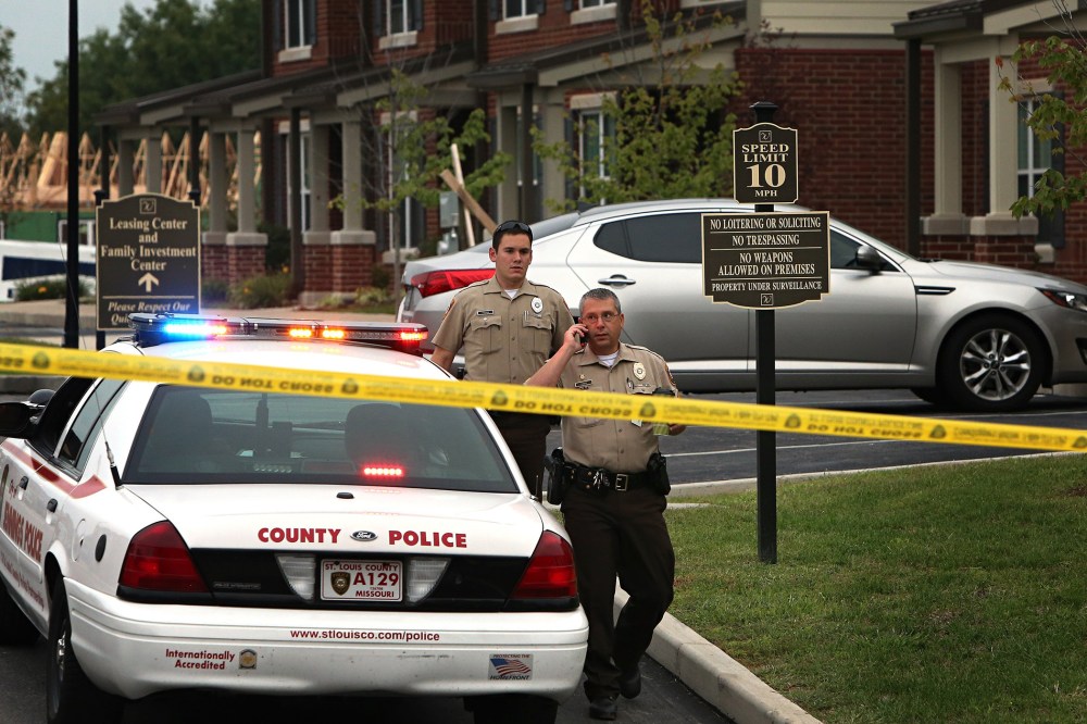 St. Louis County police officers investigate the scene of a fatal police officer involved shooting on Sept. 18, 2014 in Jennings, Mo.
