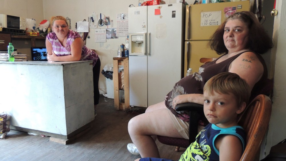 Renee Adams, left, posing with her mother Irene Salyers and son Joseph, 4, at their produce stand in Council, Va, July 12, 2013.