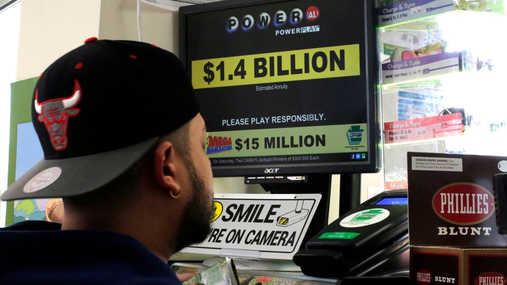A man buys Powerball tickets at a convenience store in Lancaster, Pa., Jan. 11, 2016. (Photo by Gene J. Puskar/AP)