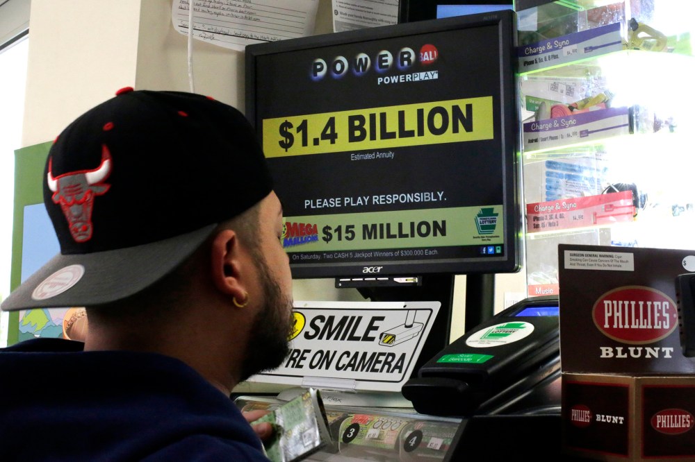A man buys Powerball tickets at a convenience store in Lancaster, Pa., Jan. 11, 2016. (Photo by Gene J. Puskar/AP)