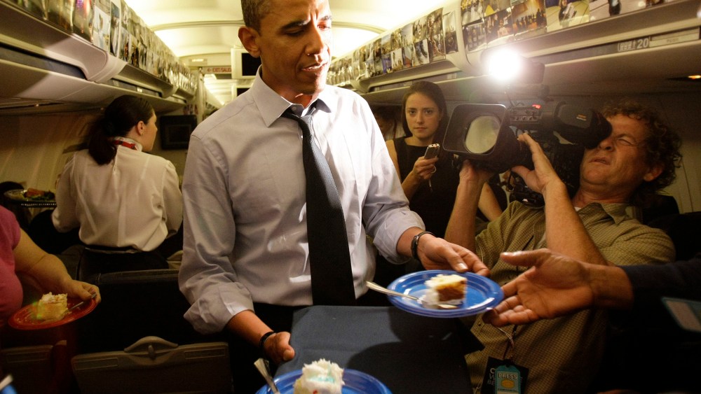 Then, Democratic presidential candidate Sen. Barack Obama, D-Ill., serves birthday cake to the press corps on his birthday while in flight, Aug. 4, 2008. (Photo by Alex Brandon/AP)