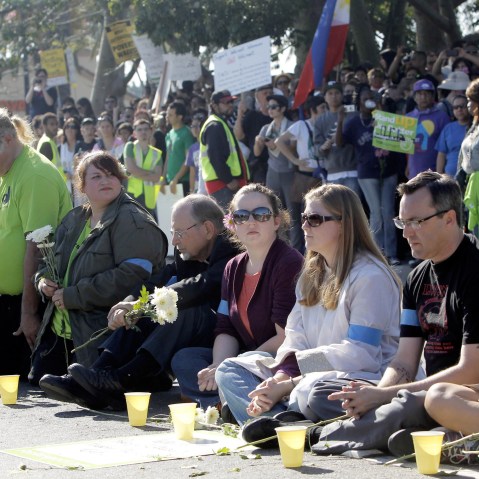 Protestors sit outside the Walmart store Friday Nov. 23, 2012 in Paramount, Calif. Wal-Mart employees and union supporters are taking part in today's nationwide demonstration for better pay and benefits A union-backed group called OUR Walmart, which...