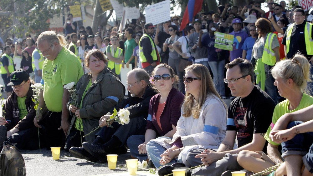 Protestors sit outside the Walmart store Friday Nov. 23, 2012 in Paramount, Calif. Wal-Mart employees and union supporters are taking part in today's nationwide demonstration for better pay and benefits A union-backed group called OUR Walmart, which...