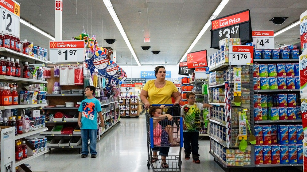 A mother and her children shop for groceries at the local Walmart in the outskirts of Harlan, Harlan, KY.
