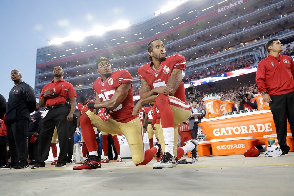 San Francisco 49ers safety Eric Reid (35) and quarterback Colin Kaepernick (7) kneel during the national anthem before an NFL football game against the Los Angeles Rams, Sept. 12, 2016, in Santa Clara, Calif. (Photo by Marcio Jose Sanchez/AP)