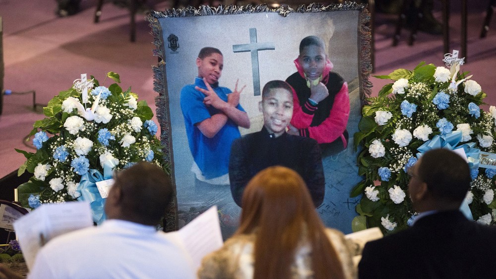 Family and friends sit and listen to kinds words being spoke during a memorial set up for Tamir Rice during the memorial ceremony for Tamir Rice, at the Mt. Sinai Baptist CHurch in Cleveland on Wednesday, Dec. 3, 2014.