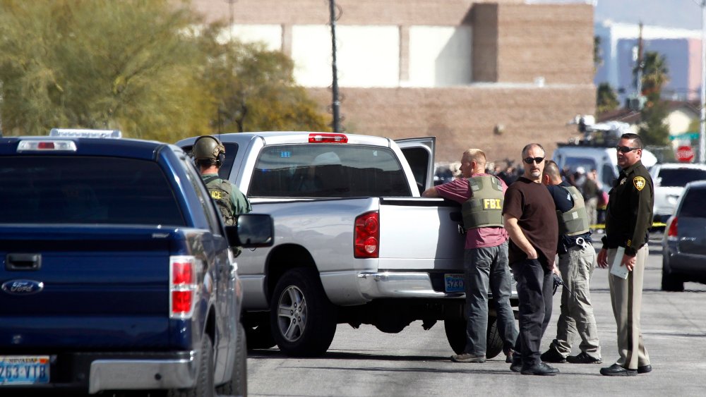 Las Vegas Metro Police officers and FBI agents stand in the street after a stand-off in Las Vegas on Feb. 19, 2015.