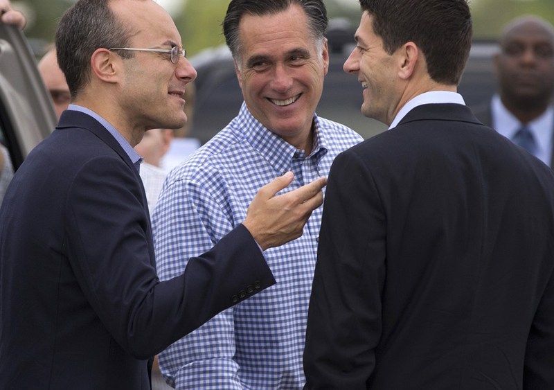 Republican presidential candidate Mitt Romney talks with foreign policy adviser Dan Senor (left) and his vice presidential running mate, Rep. Paul Ryan, R-Wis., before boarding his campaign plane at Daytona International Airport, Oct. 20 in Daytona...