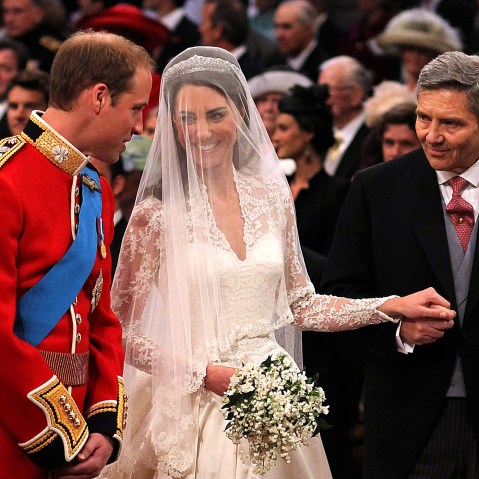 Prince William speaks to his bride, Catherine Middleton as she holds the hand of her father Michael Middleton at Westminster Abbey on April 29, 2011 in London, England. (Photo by Dominic Lipinski/WPA Pool/Getty)