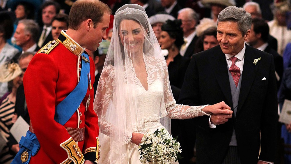 Prince William speaks to his bride, Catherine Middleton as she holds the hand of her father Michael Middleton at Westminster Abbey on April 29, 2011 in London, England. (Photo by Dominic Lipinski/WPA Pool/Getty)