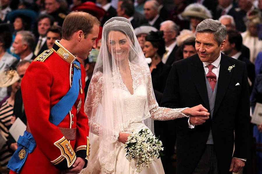 Prince William speaks to his bride, Catherine Middleton as she holds the hand of her father Michael Middleton at Westminster Abbey on April 29, 2011 in London, England. (Photo by Dominic Lipinski/WPA Pool/Getty)