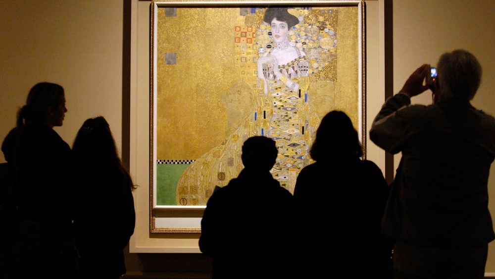 Museum visitors study 1907 painting by Austrian artist Gustav Klimt in Los Angeles
