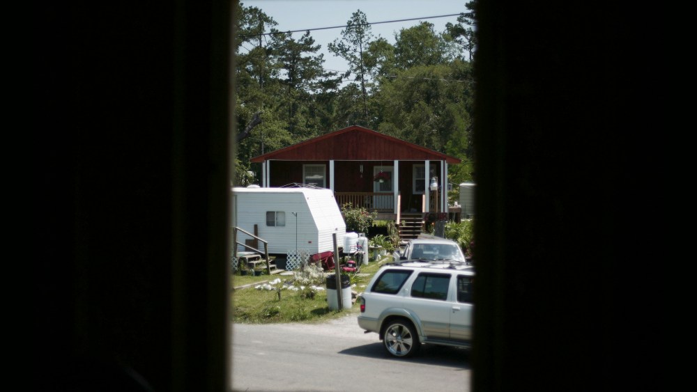 A rebuilt house is seen from an other, both destroyed by hurricane Katrina nearly two years before at Pearlington, Miss., May 10, 2007. (Photo by Carlos Barria/Reuters)