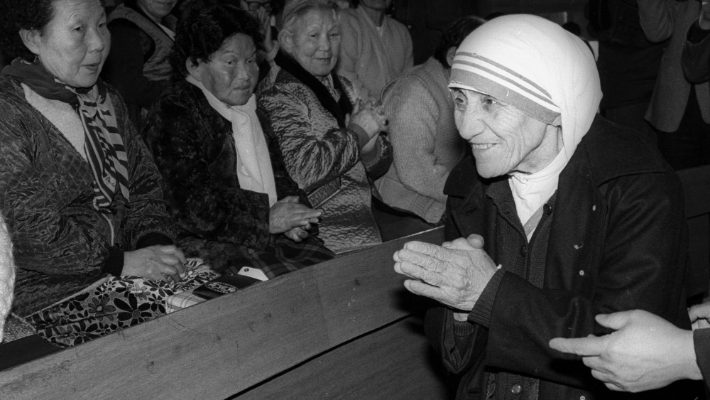 Mother Teresa is welcomed by aged women lepers on arriving at St. Lazarus Leprosy Village's church in Shinhung, Korea