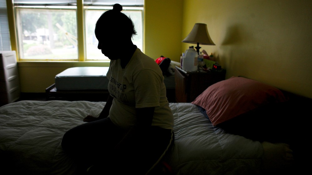 A pregnant victim of domestic violence rests in her room at Mutual Ground's shelter in Aurora, Illinois.