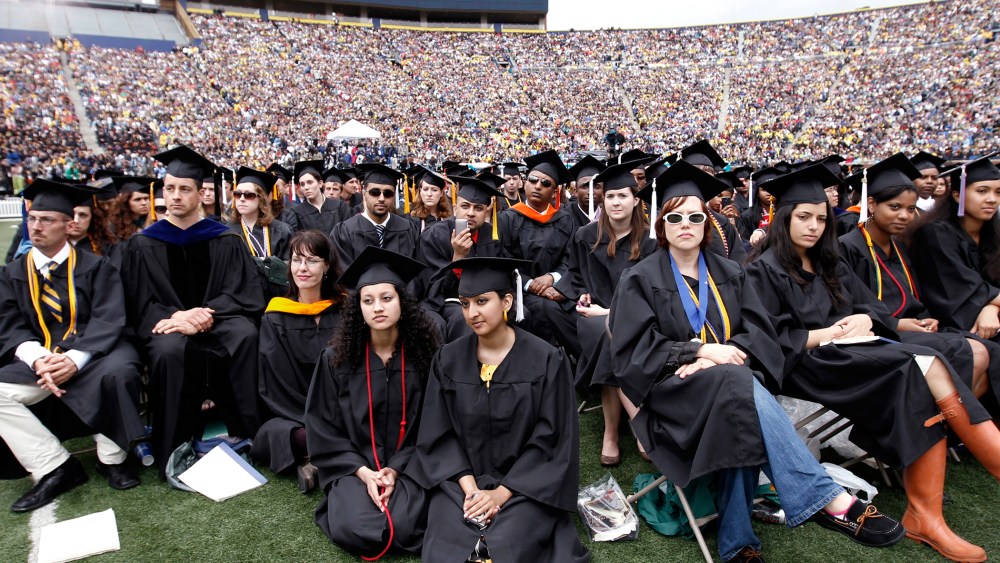 Graduating students listen to U.S. President Obama speak during commencement at the University of Michigan